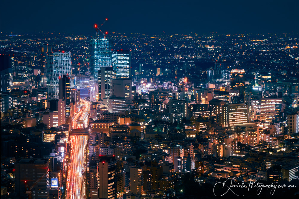 Japan Aerial Tokyo at Night with Light Trails on Streets below